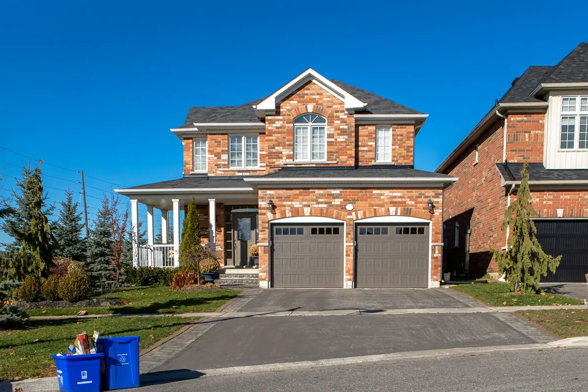 Brick home with a taupe two-car garage door