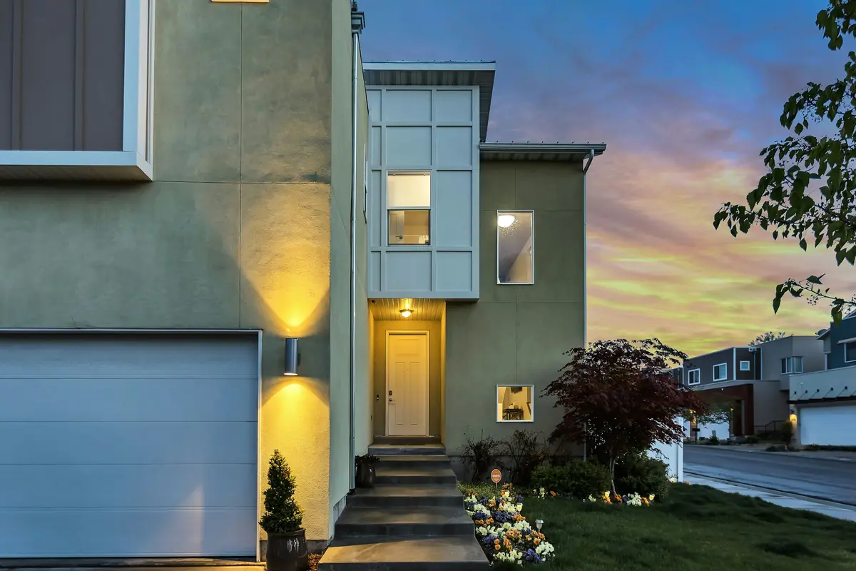 Contemporary home at dusk with a white garage door