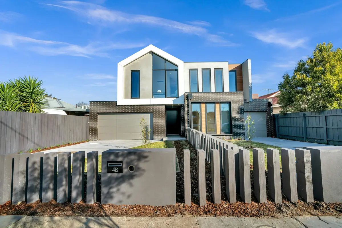 Modern home with a dark garage door and a short driveway